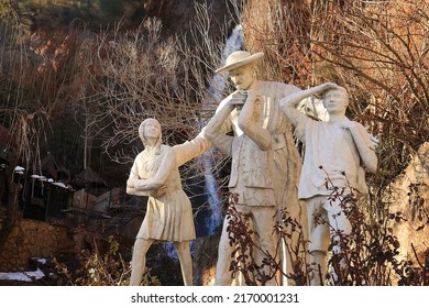 Bcharreh, Lebanon, February 12, 2022: A Sculpture Of The Christian Saint, Don Bosco, With A Group Of School Children.