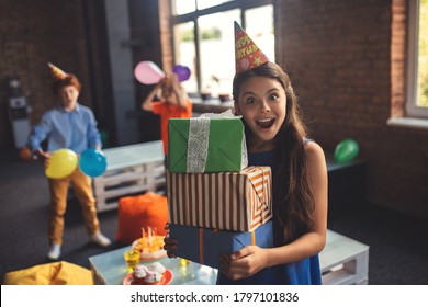 Bday. Pretty Girl In A Hat Holding Presents And Looking Excited