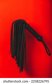 BDSM spanking toys with a red background