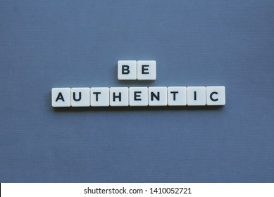 ' Be Authentic ' word made of square letter word on grey background.