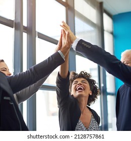 Be Bold In The Pursuit Of Success. Shot Of A Group Of Colleagues Giving Each Other A High Five.