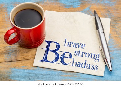 Be brave, be strong, be badass - handwriting on a napkin with a cup of coffee