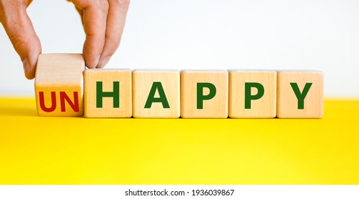Be happy, do not unhappy symbol. Businessman turns the wooden cube and changes the word 'unhappy' to 'happy'. Beautiful yellow table, white background. Business, happy or unhappy concept. Copy space. - Shutterstock ID 1936039867