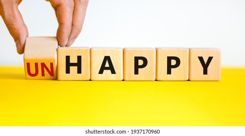 Be happy, do not unhappy symbol. Businessman turns the wooden cube and changes the word 'unhappy' to 'happy'. Beautiful yellow table, white background. Business, happy or unhappy concept. Copy space. - Shutterstock ID 1937170960