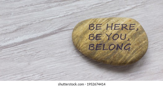Be here, be you, belong symbol. Beautiful stone with words 'Be here, be you, belong' on beautiful white wooden background. Diversity, business, inclusion and belonging concept. - Shutterstock ID 1952674414