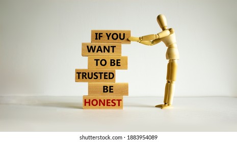 Be honest symbol. Wooden blocks with words 'If you want to be trusted be honest'. Wooden model of human. Beautiful white background, copy space. Business and be honest concept.