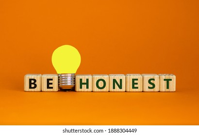 Be honest symbol. Wooden cubes with words 'be honest'. Yellow light bulb. Beautiful orange background. Business and be honest concept. Copy space.