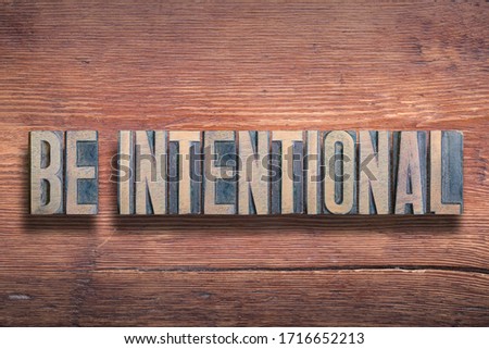 be intentional phrase combined on vintage varnished wooden surface

