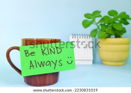 Be kind always motivation and inspiration kindness concept. Selective focus of a cup of coffee with handwritten bright paper note.