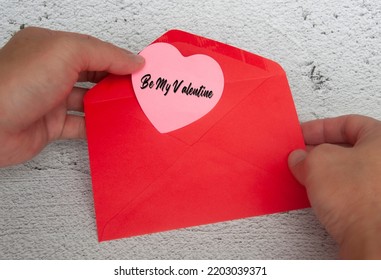 Be My Valentine Text On Heart Shape Notepad In Red Envelope. Romance And Relationship Concept.