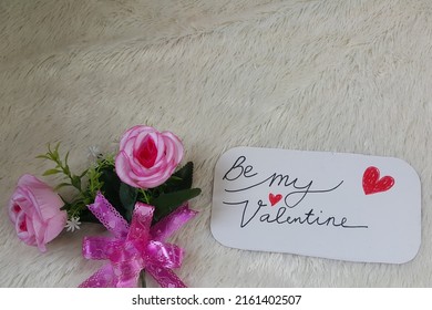 Be My Valentine Text And Pink Rose Flower. Selective Focus.