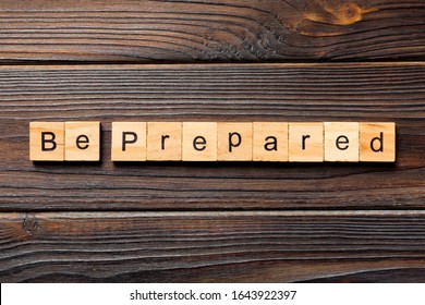 BE PREPARED word written on wood block. BE PREPARED text on wooden table for your desing, concept.