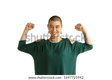 Be strong. Portrait of young caucasian woman with freaky appearance on white background. Unusual look with tattoos and bald. Human emotions, facial expression,sales, ad concept. Youth culture.