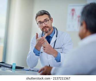 Be Sure To Follow Your Doctors Orders. Shot Of A Mature Doctor Having A Consultation With A Patient In His Office.