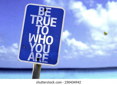 Be True To Who You Are Sign With A Beach On Background