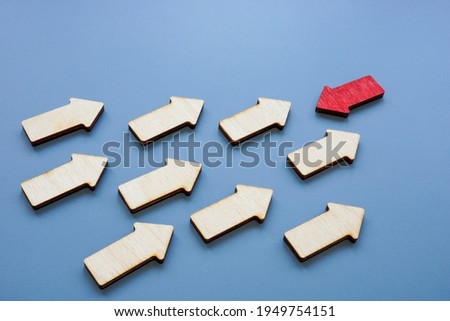 Be unique, assertive and confident concept. Crowd of arrows and red one.