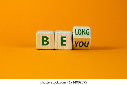 Be you, belong symbol. Turned a cube and changed words 'be you' to 'belong'. Beautiful orange background. Business, belonging and be you belong concept. Copy space. - Shutterstock ID 1914009595