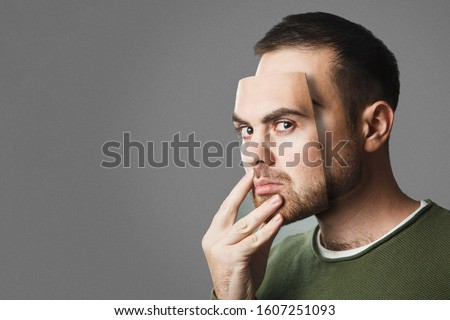 Be Yourself. Handsome man holds a mask of his face. Copy space.