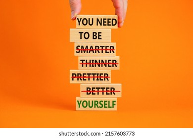 Be yourself symbol. Wooden blocks with words 'you need to be yourself, not smarter, thinner, prettier, better'. Man hand. Beautiful orange background, copy space. Psychological, be yourself concept.