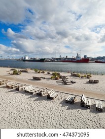 Beach At Aarhus In Denmark, Harbor In The Background 