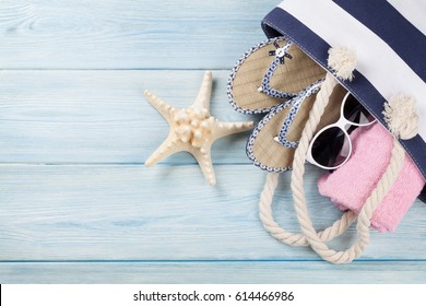 Beach Accessories. Bag, Towel, Sunglasses And Flip-flops On Wooden Background. Top View With Copy Space