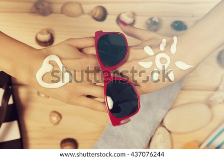 Beach accessories on wooden board.

