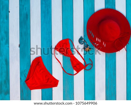 Beach accessories set,red beach swimsuit on a blue background