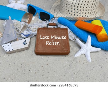 Beach accessories with the text Last Minute Travel on a suitcase. German inscription means last minute travel. - Shutterstock ID 2284168593