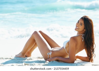 Beach babe. A gorgeous young woman relaxing on the beach.