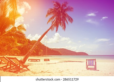 Beach Background  With Coconut Tree And Beach Wooden Bed On Sand With Beautiful Blue Sea And Cloudy Sky,Image For Summer Fun Party Travel Concept.