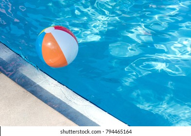 Beach Ball in swimming pool on a beautiful summer day.  