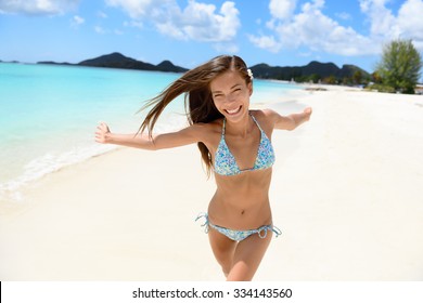 Beach Bikini Woman Happy Running With Aspiration, Joyful, Free And Playful On Jolly Beach, Antigua Girl On Travel Vacation Holidays Having Fun. Asian Chinese Caucasian Female Model.