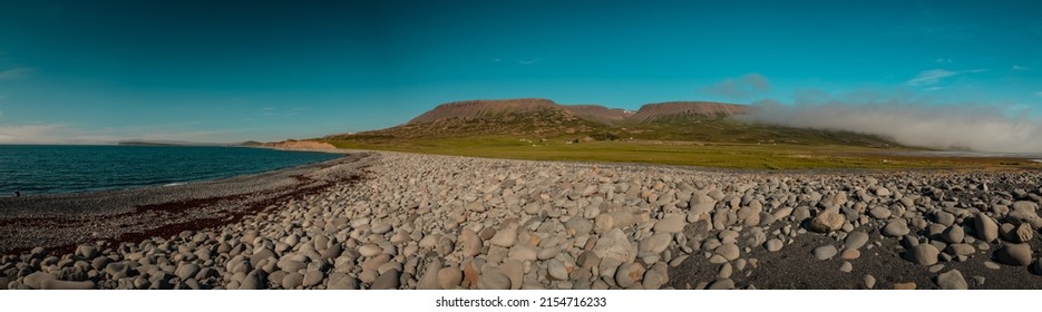 Beach At Bilastaedi, Iceland, Close To Haganes On A Sunny Summer Day. View Of A Beach And Round Rocks In Wide Panorama Of The Stone Reef.