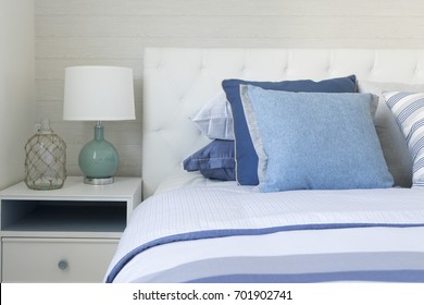 beach blue bedroom with cozy pillow and table lamp