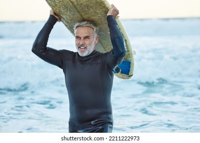 Beach, board and man surfing the waves in the water on holiday in the Maldives during travel in summer. Mature surfer happy and thinking with smile in ocean on vacation in nature for peace and calm - Powered by Shutterstock