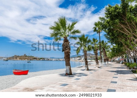 Beach and Bodrum Castle at background view in Bodrum Town. Bodrum is populer tourist destination in Turkey.