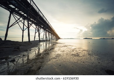 beach with bridge in long exposure