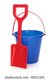 Beach Bucket And Spade In Blue And Red Colours Isolated Over White Background.