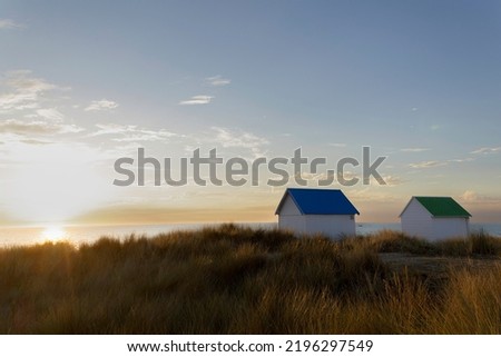Beach cabins in Gouville sur Mer, Manche, Normandy, France in various lights