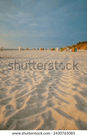 Beach cabins on white sand. Beach baskets on the sea coast of the northern sea. Vacation on the North Sea. Beaches of the Frisian Islands in Germany. summer mood. 