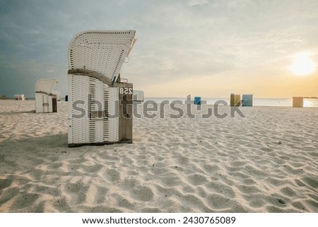 Beach cabins on white sand. Beach wicker baskets on the sea coast of the northern sea. Vacation on the North Sea. Beaches of the Frisian Islands in Germany. Sea summer mood. 