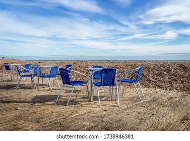 Beach Cafe Terrace, UK, Deserted With No Customers. Just Empty Chairs.