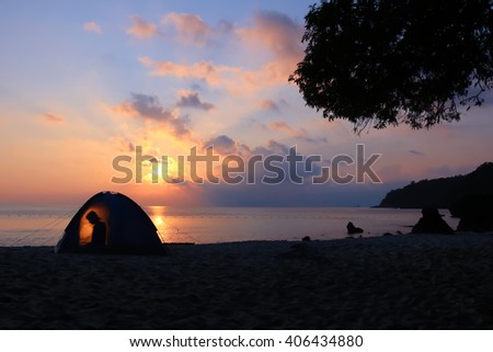 Beach camp and the shadow of a woman in the tents from morning sun.At ang thong island.