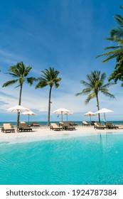 Beach Chair Around Swimming Pool In Hotel Resort With Sea Beach Background - Holiday And Vacation Concept