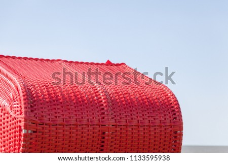 Similar – lost and found. fundstück. eine pinke sonnenbrille liegt auf einem roten strandkorb