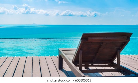 Beach Chair On Swimming Pool Side And Beautiful Blue Sea View For Summer Background