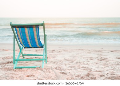 Beach Chair At Side Of Beach With Sunset Background On Summer Season