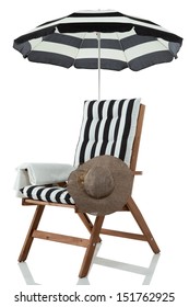 Beach chair with umbrella, hat and towel