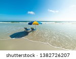 Beach chairs and parasol in Daytona Beach. Florida, USA