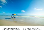 Beach chairs and parasol in world famous Daytona Beach. Florida, USA